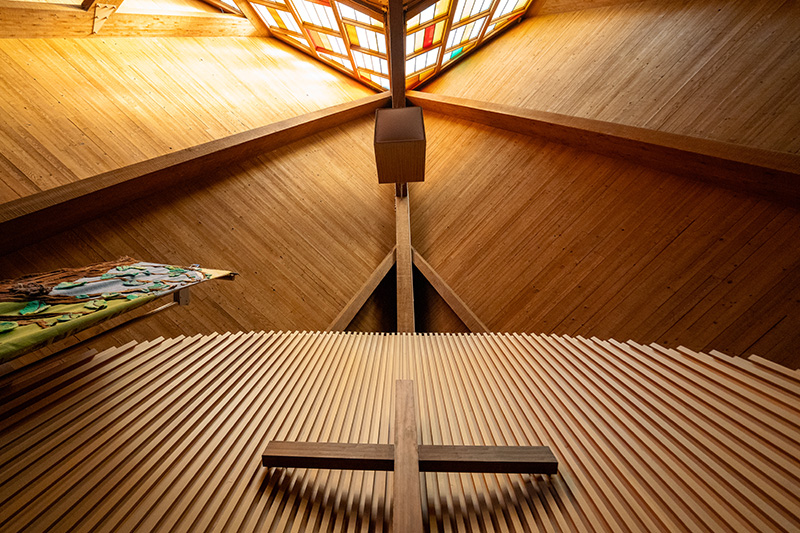 The cross and stained glass at the front of the sanctuary